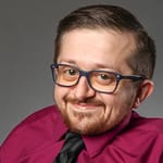 Rob Parke in Burgundy shirt wearing glasses