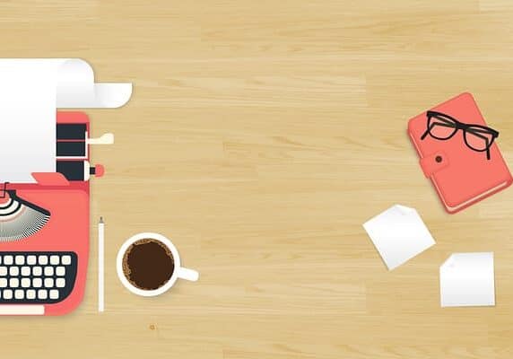 Realistic workplace organization. Top view with textured table, typewriter, stickers, glasses, diary and coffee mug